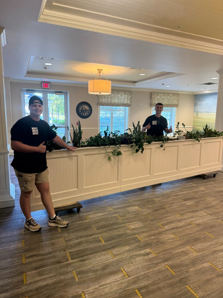 Two Move Move Move movers with a long planter box on furniture dollies