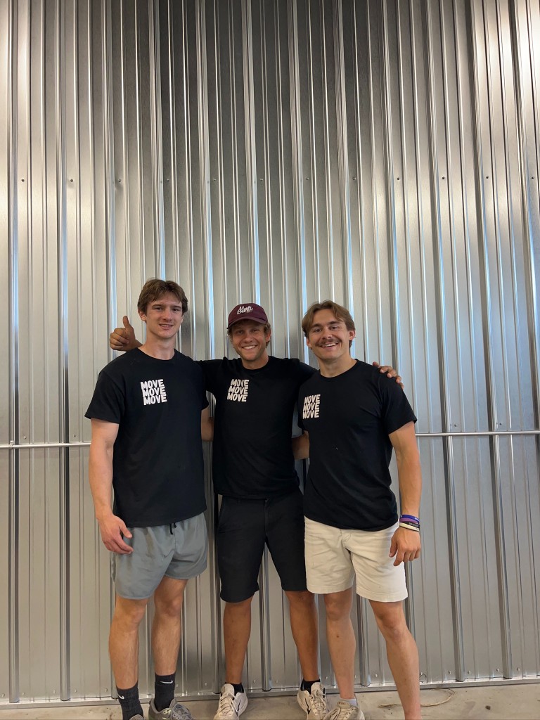 Three Move Move Move movers in branded shirts standing together